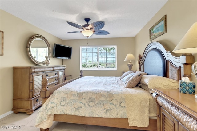 1150 Wildwood Lakes Blvd Unit 306, Naples, FL 34104 - bedroom featuring light tile patterned flooring, multiple windows, a ceiling fan, and baseboards