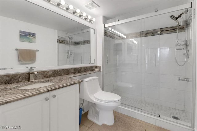1150 Wildwood Lakes Blvd Unit 306, Naples, FL 34104 - full bathroom featuring a shower stall, vanity, toilet, visible vents, and tile patterned flooring