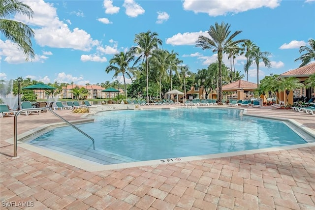 1150 Wildwood Lakes Blvd Unit 306, Naples, FL 34104 - community pool featuring a patio