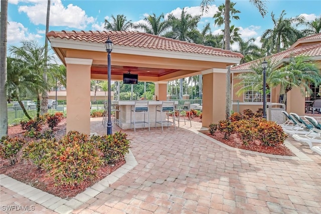 1150 Wildwood Lakes Blvd Unit 306, Naples, FL 34104 - view of patio / terrace featuring outdoor dry bar, a gazebo, and fence