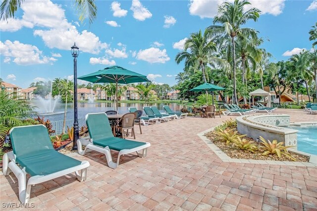 1150 Wildwood Lakes Blvd Unit 306, Naples, FL 34104 - exterior space featuring a community pool and a water view