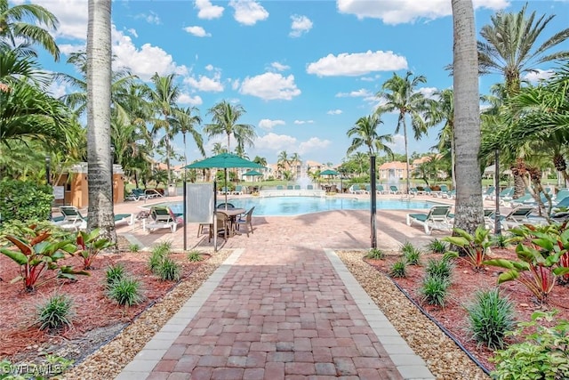 1150 Wildwood Lakes Blvd Unit 306, Naples, FL 34104 - community pool featuring a patio