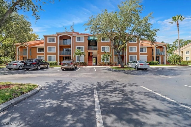 1150 Wildwood Lakes Blvd Unit 306, Naples, FL 34104 - view of building exterior with uncovered parking