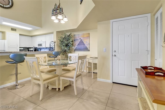 1150 Wildwood Lakes Blvd Unit 306, Naples, FL 34104 - dining room featuring baseboards, visible vents, and light tile patterned floors