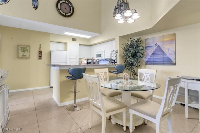 1150 Wildwood Lakes Blvd Unit 306, Naples, FL 34104 - dining room featuring light tile patterned floors, visible vents, and baseboards