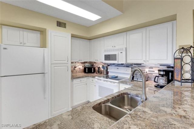 1150 Wildwood Lakes Blvd Unit 306, Naples, FL 34104 - kitchen featuring light stone countertops, a sink, backsplash, white appliances, and white cabinets