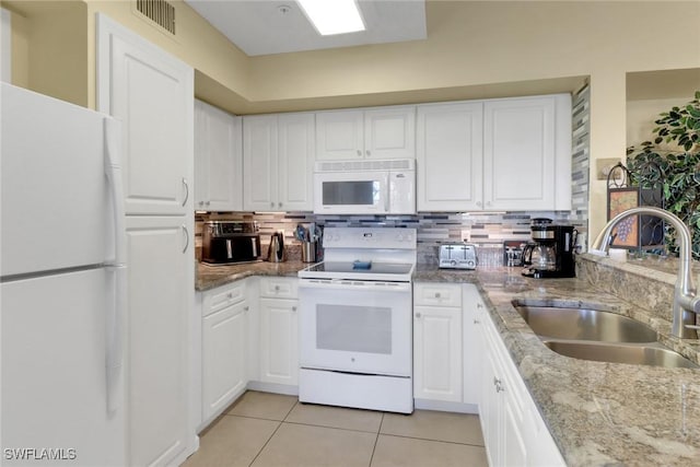 1150 Wildwood Lakes Blvd Unit 306, Naples, FL 34104 - kitchen with a sink, light tile patterned flooring, visible vents, white cabinetry, and white appliances