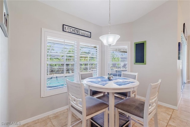 dining room featuring baseboards and light tile patterned flooring