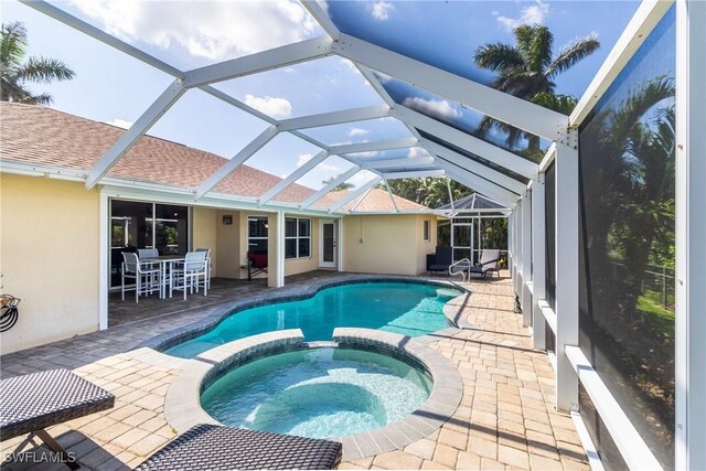 view of pool featuring a pool with connected hot tub and a patio area