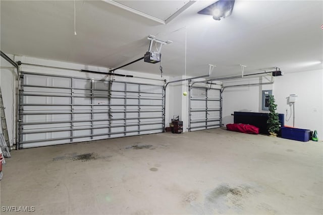 garage with a garage door opener and electric panel
