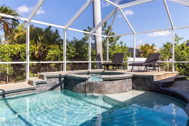 outdoor pool with a lanai, a patio area, and an in ground hot tub