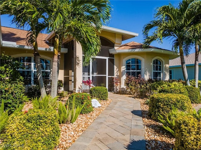 entrance to property featuring stucco siding