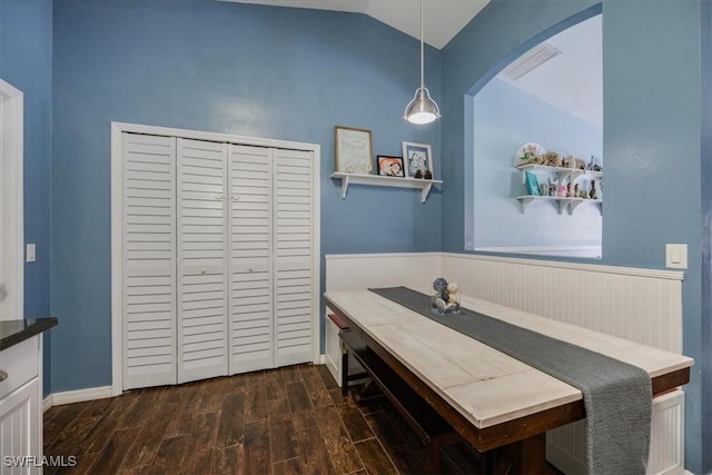 3322 SW 29th Ave, Cape Coral, FL 33914 - dining area featuring arched walkways, visible vents, a wainscoted wall, dark wood-style flooring, and lofted ceiling