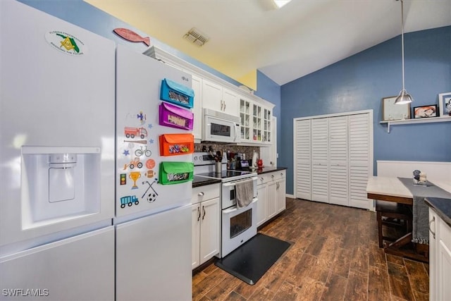 3322 SW 29th Ave, Cape Coral, FL 33914 - kitchen with visible vents, white cabinets, dark countertops, white appliances, and vaulted ceiling