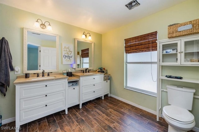 3322 SW 29th Ave, Cape Coral, FL 33914 - bathroom with toilet, baseboards, vanity, and wood finished floors