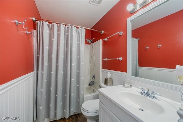 3322 SW 29th Ave, Cape Coral, FL 33914 - full bath featuring vanity, visible vents, toilet, wainscoting, and shower / tub combo with curtain