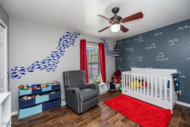 3322 SW 29th Ave, Cape Coral, FL 33914 - bedroom with ceiling fan, baseboards, wood finish floors, and a crib