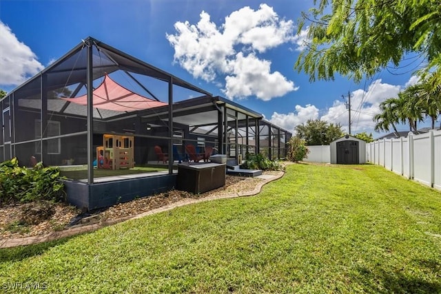 3322 SW 29th Ave, Cape Coral, FL 33914 - rear view of house featuring a shed, a lawn, a fenced backyard, an outbuilding, and a lanai