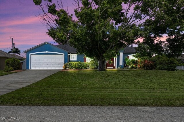 3322 SW 29th Ave, Cape Coral, FL 33914 - view of front of home featuring driveway, stucco siding, an attached garage, and a front lawn
