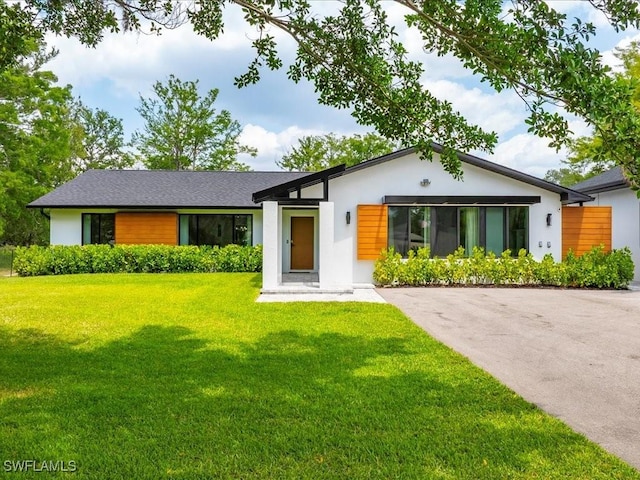 5237 Cherry Wood Dr, Naples, FL 34119 - ranch-style house with a front lawn and stucco siding