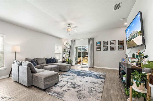2112 NE 4th Place, Cape Coral, FL 33909 - living room featuring plenty of natural light, a ceiling fan, and light wood-style floors