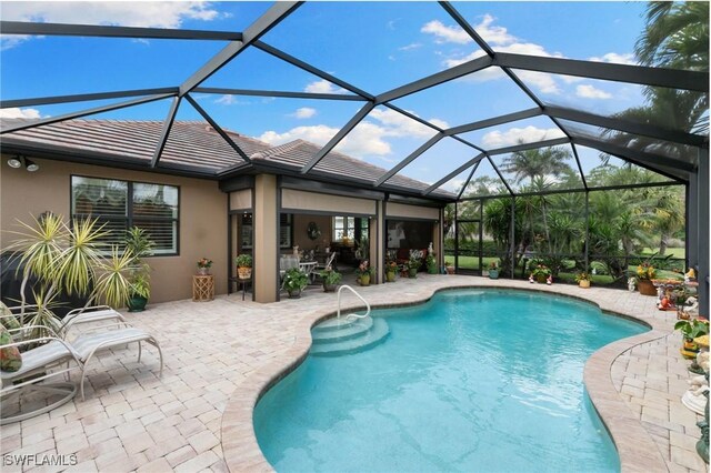 outdoor pool with a patio area