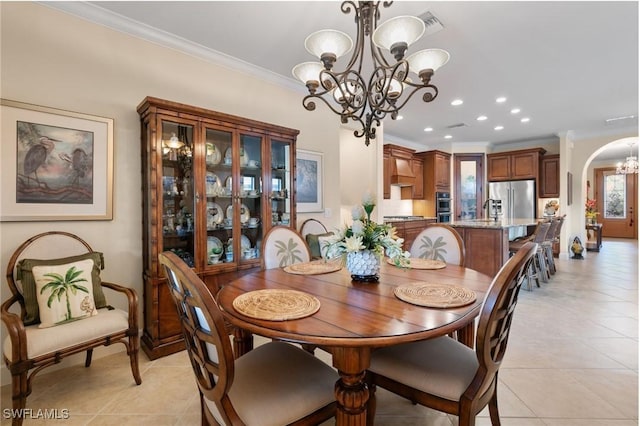 dining area featuring recessed lighting, an inviting chandelier, light tile patterned floors, arched walkways, and crown molding
