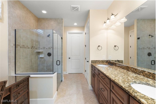 full bathroom with baseboards, visible vents, a sink, and a stall shower