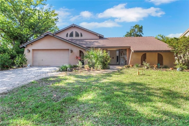 single story home with a front lawn, a tiled roof, driveway, a garage, and stucco siding