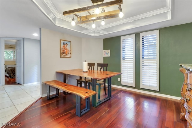 dining area featuring baseboards, a tray ceiling, and ornamental molding