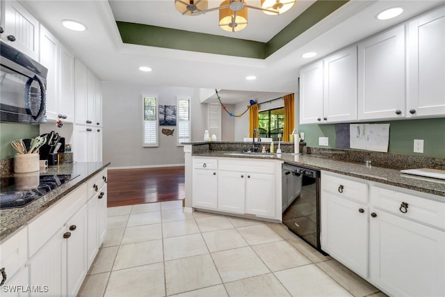 kitchen featuring a sink, recessed lighting, black appliances, and a healthy amount of sunlight
