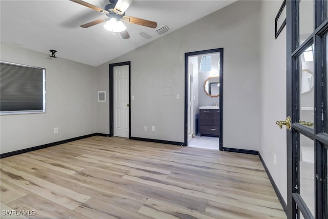 unfurnished bedroom featuring lofted ceiling, visible vents, baseboards, and light wood-style flooring