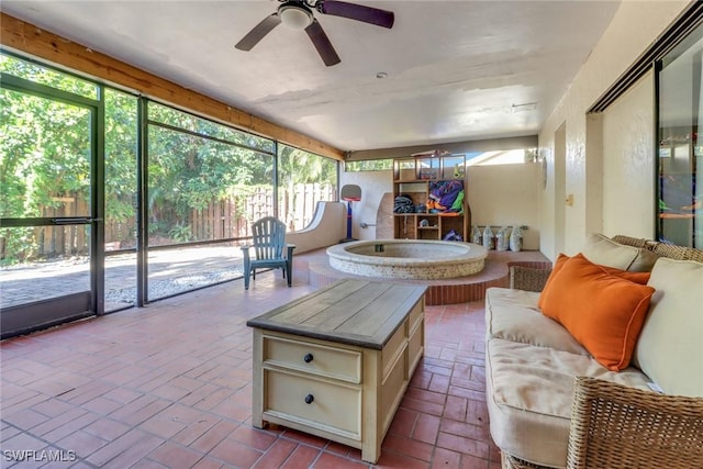 sunroom featuring outdoor lounge area and a ceiling fan