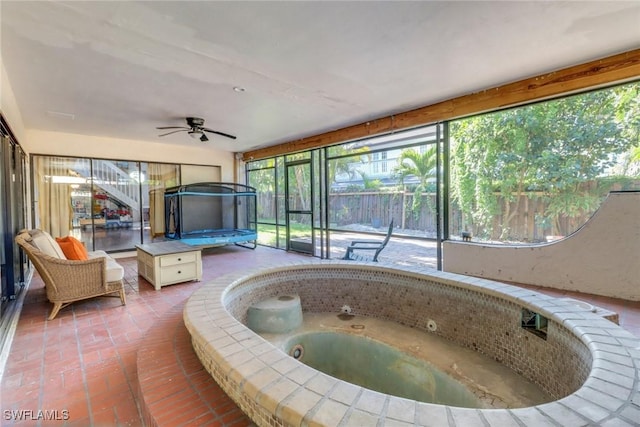 sunroom featuring a hot tub and ceiling fan