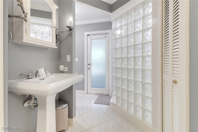 bathroom with ornamental molding, tile patterned floors, and a closet