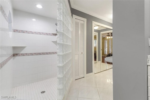 bathroom featuring a walk in shower, a ceiling fan, tile patterned flooring, a closet, and ornamental molding