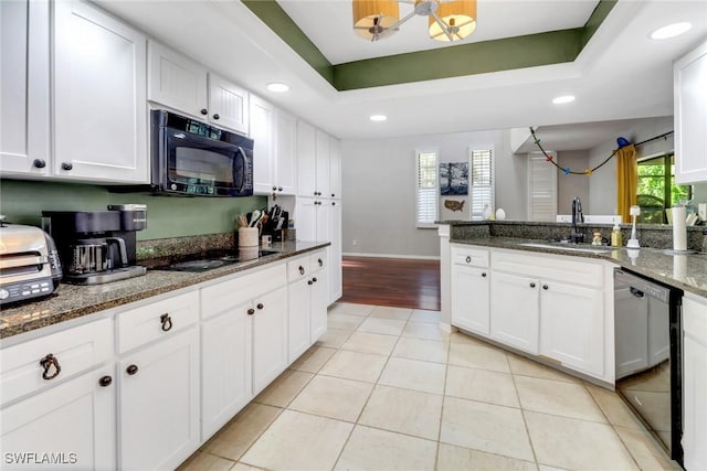 kitchen featuring white cabinets, a sink, recessed lighting, black appliances, and light tile patterned floors