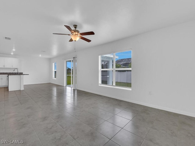 1512 NW 31st Ave, Cape Coral, FL 33993 - unfurnished living room featuring a ceiling fan, tile patterned floors, visible vents, and baseboards