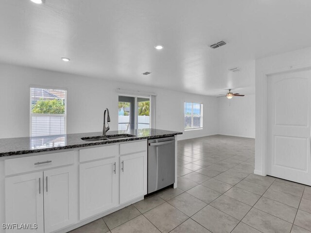 1512 NW 31st Ave, Cape Coral, FL 33993 - kitchen with visible vents, stainless steel dishwasher, a sink, light tile patterned floors, and dark stone counters