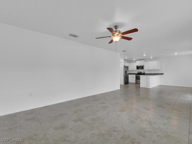 1512 NW 31st Ave, Cape Coral, FL 33993 - unfurnished living room with a ceiling fan, visible vents, light tile patterned flooring, and recessed lighting