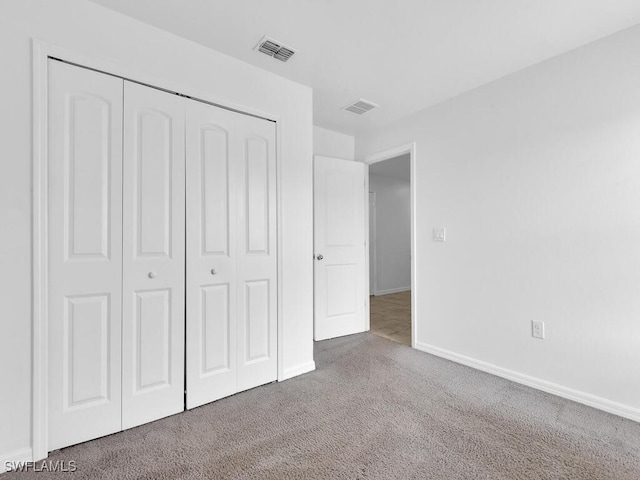 1512 NW 31st Ave, Cape Coral, FL 33993 - unfurnished bedroom with carpet flooring, baseboards, visible vents, and a closet