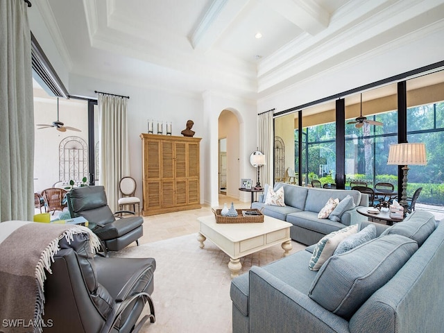 living room with arched walkways, a healthy amount of sunlight, beamed ceiling, and crown molding