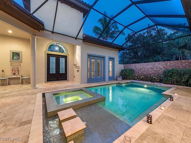 view of pool with a patio area, french doors, and a pool with connected hot tub