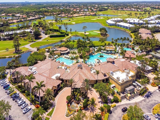 aerial view with golf course view, a residential view, and a water view
