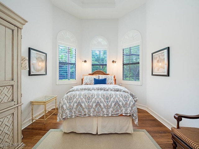 bedroom featuring dark wood-type flooring and baseboards