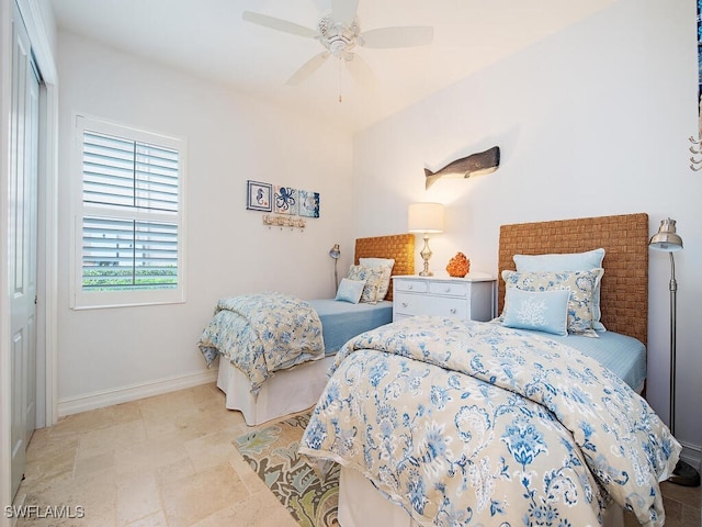 bedroom featuring baseboards and a ceiling fan