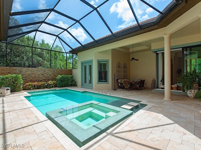 view of swimming pool featuring ceiling fan, a pool with connected hot tub, and a patio