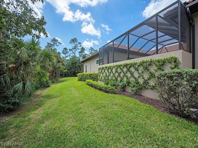 view of yard featuring glass enclosure