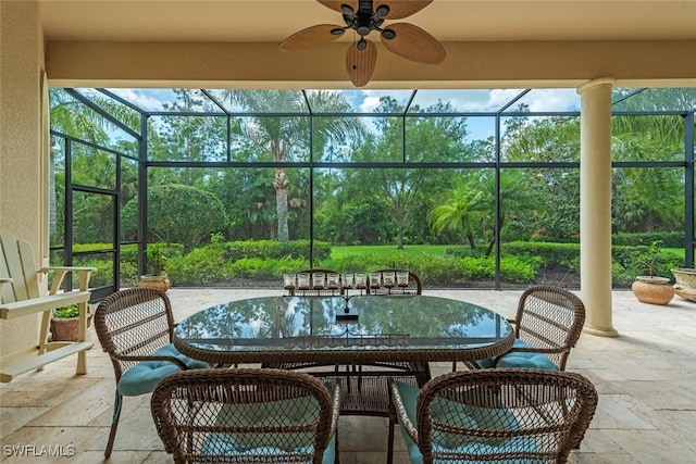 view of patio with a lanai, outdoor dining space, and ceiling fan