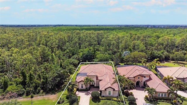 birds eye view of property with a wooded view